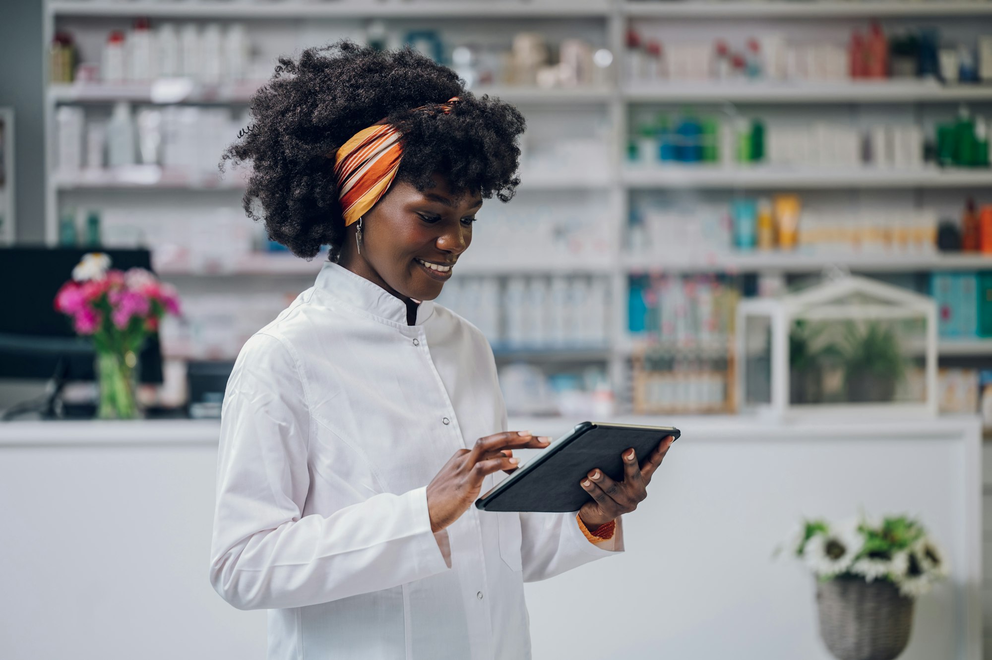 A young multiracial professional healthcare service worker is standing in a pharmacy